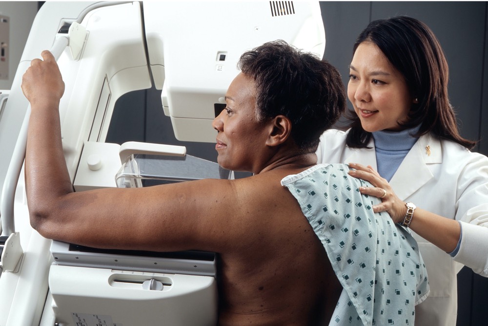 A patient undergoing breast screening mammogram